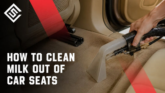 Technician cleaning milk stains from beige car seats with extractor in guide to removing spills and odors safely.